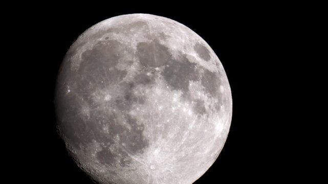 Detailed close-up video of the full moon filmed through a vintage MTO 1000A lens, showing visible craters and lunar maria in high contrast against the black night sky.