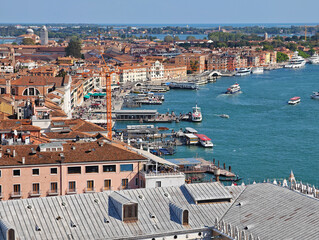 Aerial view of Venice red city rooftops and waterfront with boats