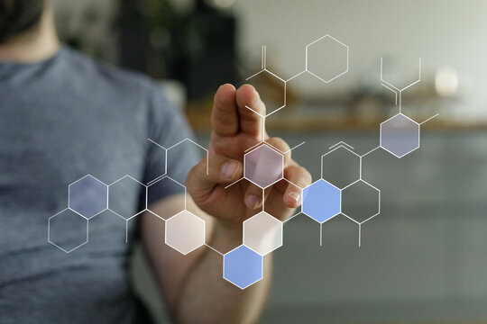 Close-up of a man's hand interacting with a holographic chemical structure, representing technology, science, and innovation. Perfect