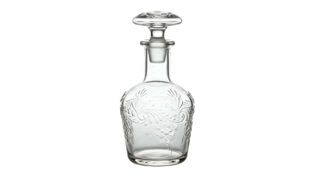 Clear crystal decanter featuring intricate floral scrollwork is isolated against a black background