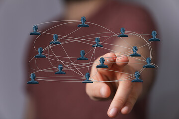 Visualize teamwork and communication with a digital network concept. A hand touches a graphic, illustrating connection, interaction, and global
