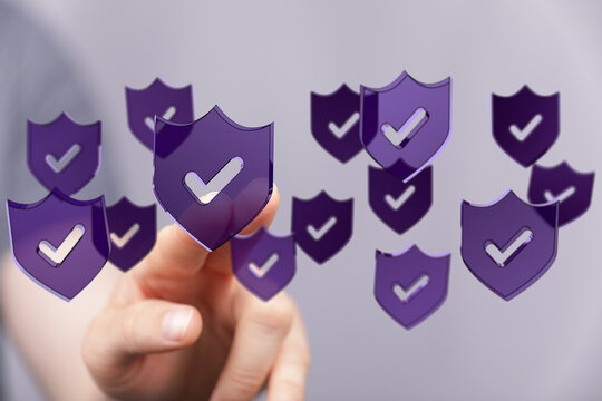 Concept of cybersecurity, data protection and safety with floating shield symbols and a hand pointing. Internet security and privacy