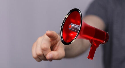 Hand pointing towards a red megaphone. Illustration for advertising, marketing and announcements. ...