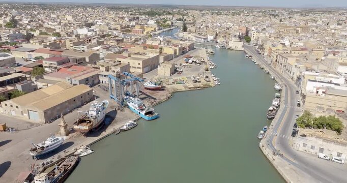 Aerial view of the Mazaro River, which bisects the city of Mazara del Vallo, in the province of Trapani, Sicily, Italy. The town's historic center is located on the banks of the river.