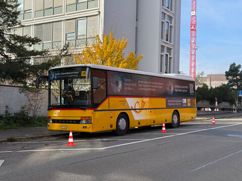 Swiss Post Bus parked at University Hospital USZ doing advertising for electronic patient record Sanela at Swiss city of Z&uuml;rich. Photo taken November 6th, 2025, Zurich, Switzerland.