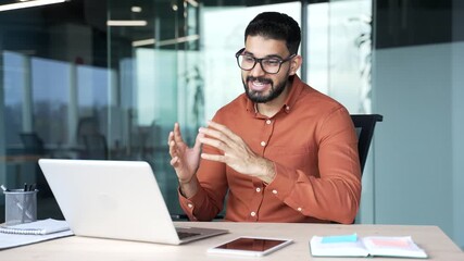Confident businessman talking on video call conference using laptop sitting at workplace in office. Manager has a business meeting. Coach has online course, training, consultation or webinar remotely - Powered by Adobe