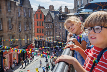 Children explore a scenic Victoria street with colorful banners