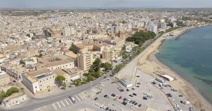Aerial view of the seafront of Mazara del Vallo, a town in the province of Trapani, Sicily, Italy. The historic center overlooks the Mediterranean Sea. TIn foreground is the city's port.