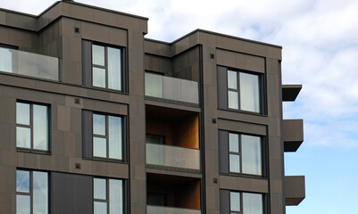 Exterior of modern dark cladding house object. Architectural detail of recessed balconies and...