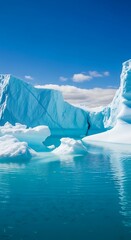 A view of large icebergs floating in the turquoise water under a clear blue sky with some clouds