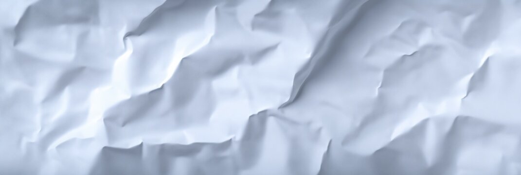 Textured white crumpled paper background with soft shadows