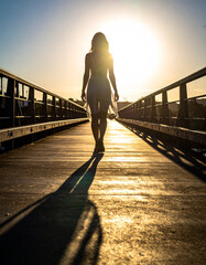 Shadow of a person walking across a bridge
