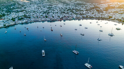 Bodrum, Turkey. Aerial drone shot of bay with stationary yachts, beachfront promenade and seaside houses in cool morning light.. Aerial View