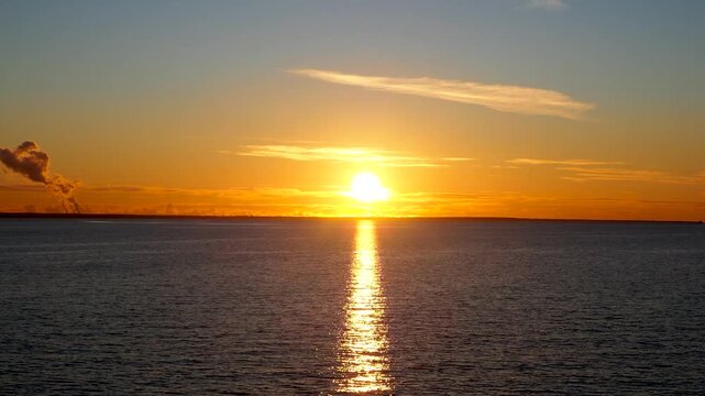 Scenic sunset over the sea. The sky is painted in bright colors. sun path is reflected in the water. Magic natural landscape. 4K footage.