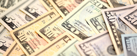 United States Dollar currency money bills. USD currency banknotes in pile with different...