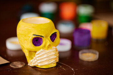 Painting plaster skulls with colored paints