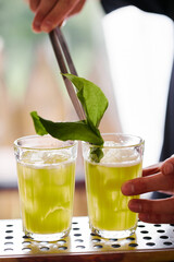 Making atmospheric rustic cocktails in faceted glasses