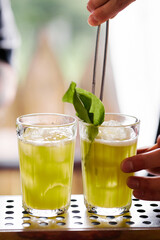 Making atmospheric rustic cocktails in faceted glasses
