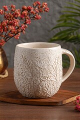 Cream Floral Design Ceramic Mug On Wooden Table