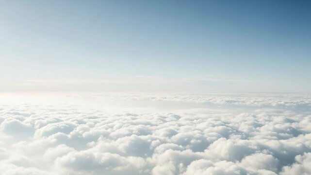 Vast expanse of fluffy white clouds stretching to the horizon under a clear, bright blue sky, offering a serene and peaceful aerial perspective