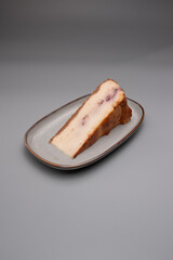 piece of cheese cake presented on a oval plate