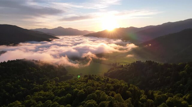 Timelapse of early morning sky glowing from deep blue to golden orange; sun rising behind distant mountain peaks, light rays spreading through misty clouds; cinematic natural landscape, serene and upl
