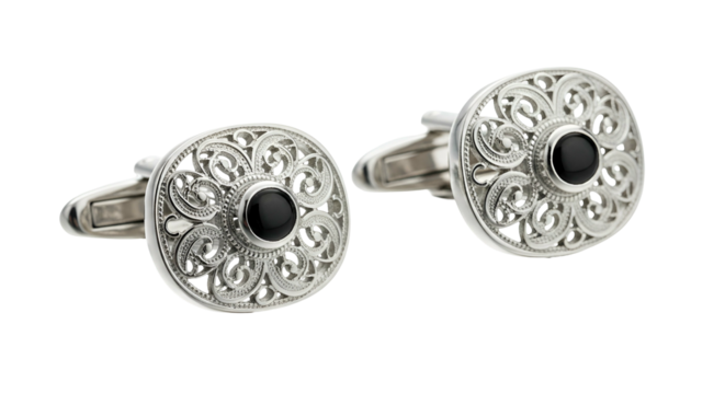 Ornate silver metal fasteners featuring central black gemstone embellishments rest against a dark background.