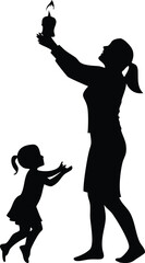 Woman lighting candle for child silhouette