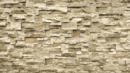 Realistic Stacked Stone Wall Texture Background - Rustic Beige Slate Veneer Close-Up.
High-resolution, photorealistic texture showcasing a section of a natural stacked stone wall. The surface features