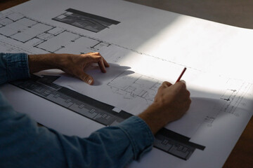 A architect draws a house plan. Hands close-up, top view. Architect Hand Sketches House Plan Design