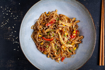 Shirataki noodles stir-fried in spicy soy sauce. Shirataki noodles with shimeji mushrooms. Asian cuisine. Top view.