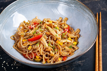 Shirataki noodles stir-fried in spicy soy sauce. Shirataki noodles with shimeji mushrooms. Asian cuisine.