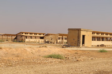 Abandoned and destroyed cattle farm in Aleppo, Syria, highlights the severe impact of war on agriculture, economy and rural communities. Symbolize loss, displacement and collapse of infrastructure.
