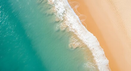 Aerial view of turquoise ocean waves crashing on a sandy beach