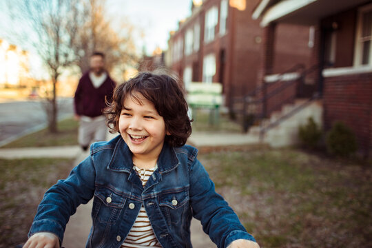 Happy child smiling on neighborhood sidewalk