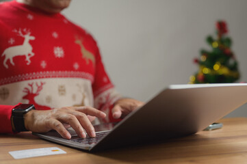 Person Doing Holiday Online Shopping on Laptop with Credit Card