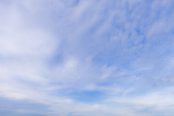 Soft focus cloud and sky background,Soft-focus light blue sky with fluffy white clouds in flowing linear formation, ideal for dreamy, calm, serene, and tranquil backgrounds.