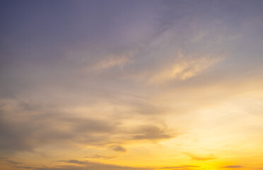 Fototapeta premium Orange sky and clouds backdrop at sunset and sunrise,Sky,sunset, beautiful , luxury soft gradient orange gold clouds and sunlight on the blue sky perfect for the background, Sunrise on morning.