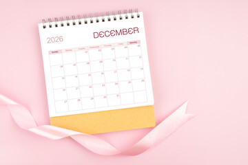 December 2026 desk calendar with pink pastel ribbon.