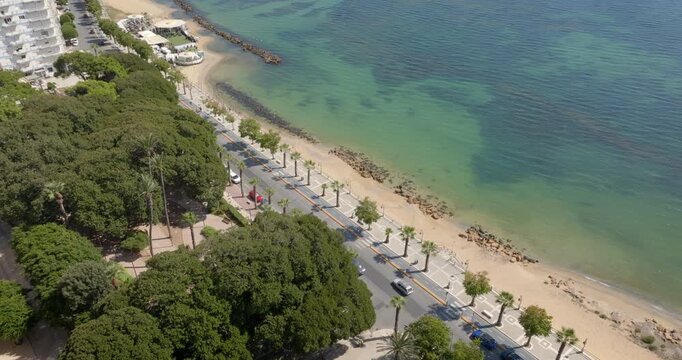 Aerial view of the seafront of Mazara del Vallo, in the province of Trapani, Sicily, Italy. A road runs along the town beach. It's a beautiful, sunny summer day.