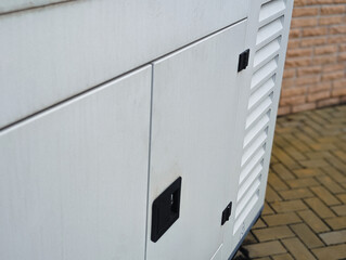 close up of white industrial power generator exterior casing