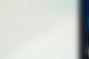 Abstract textured background with vertical lines and blue edge 