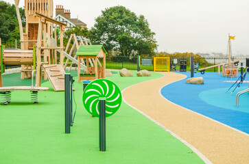 Empty childrens playground with wooden boat, slides and climbing frames