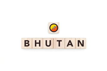 Wooden blocks bearing the name and flag of Bhutan. Bhutanese and Asian Culture, national identity, travel, and geography in an advertising space design.