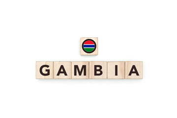 Wooden blocks bearing the name and flag of Gambia. Gambian and African Culture, national identity, travel, and geography in an advertising space design.
