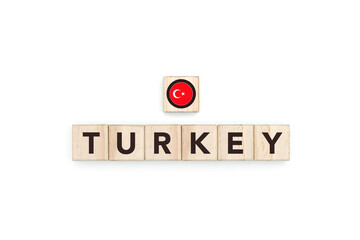 Wooden blocks bearing the name and flag of Turkey. Turkish and European and Asian Culture, national identity, travel, and geography in an advertising space design.