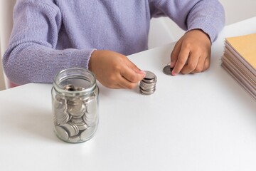 A little girl learning to save money
