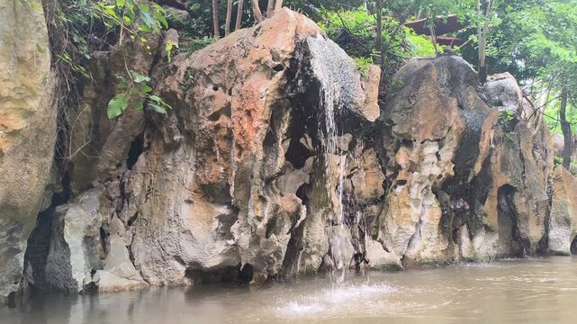 traveling sailing on river lake near cascade waterfall in tropical forest jungle