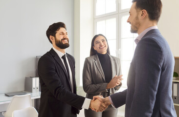 Businesspeople deal interacting, men shaking hands, woman clapping and smiling, happy and...
