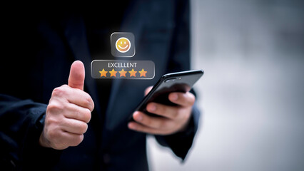 Businessman using smartphone to give five-star positive review with smiley face icon, Customers give 5-star reviews,symbolizing excellent customer feedback, and user satisfaction in digital service.